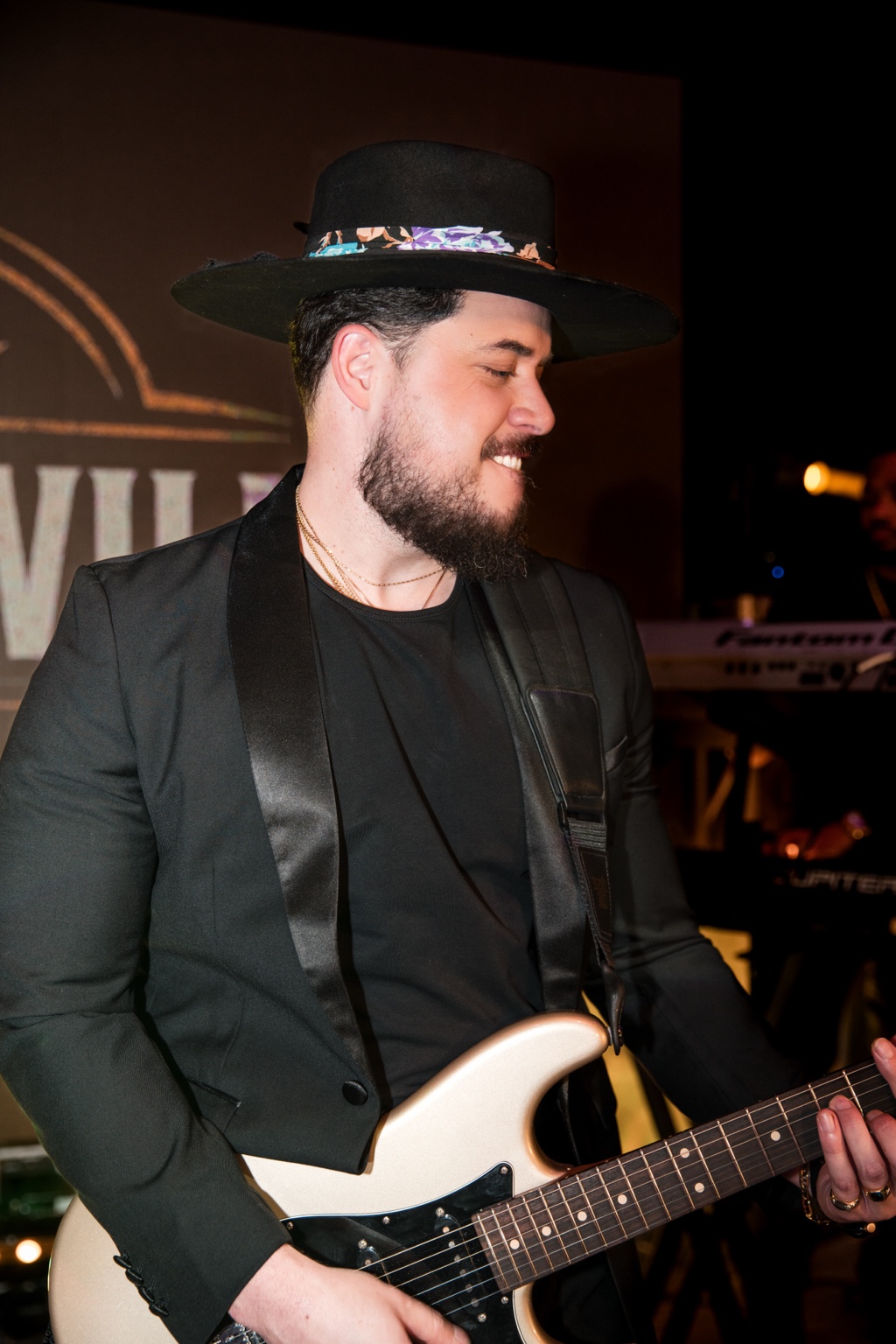 Will smiling while playing his guitar on stage